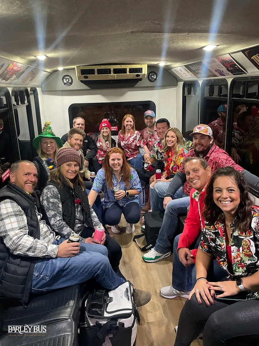 A group in holiday shirts riding together on a Barley Bus