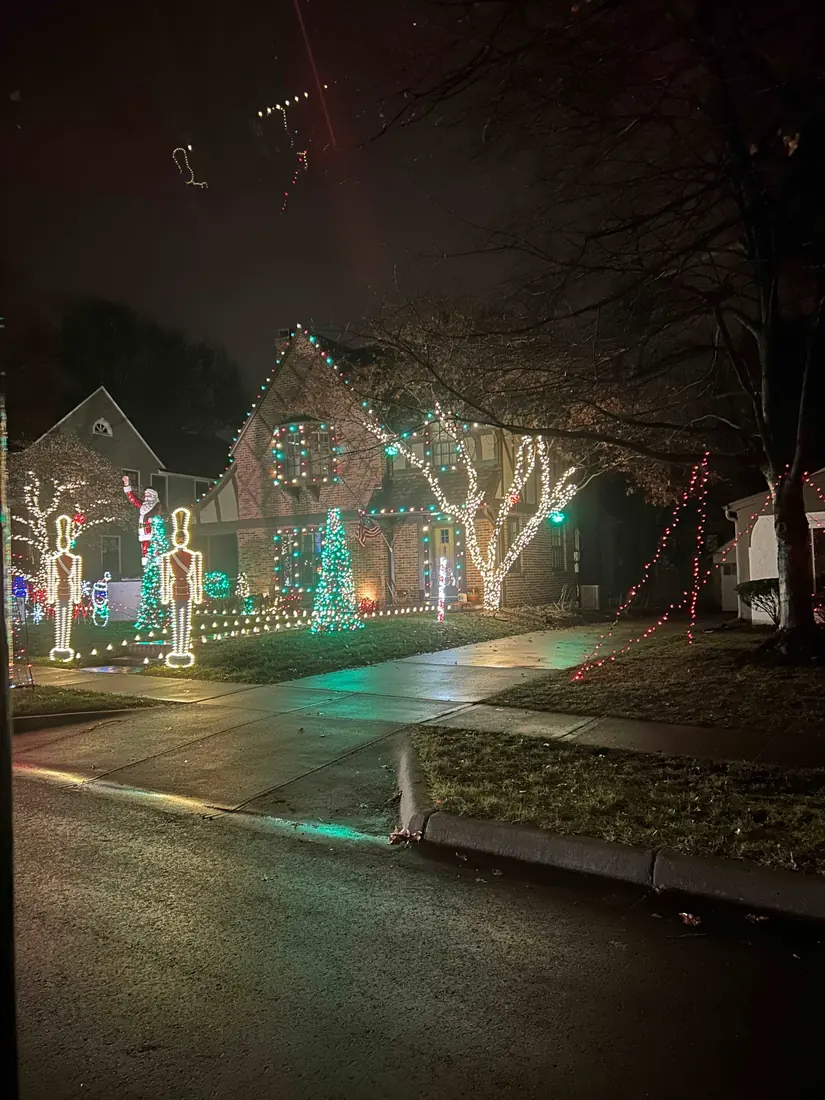 A Kansas City house decorated with a nutcracker and lit trees