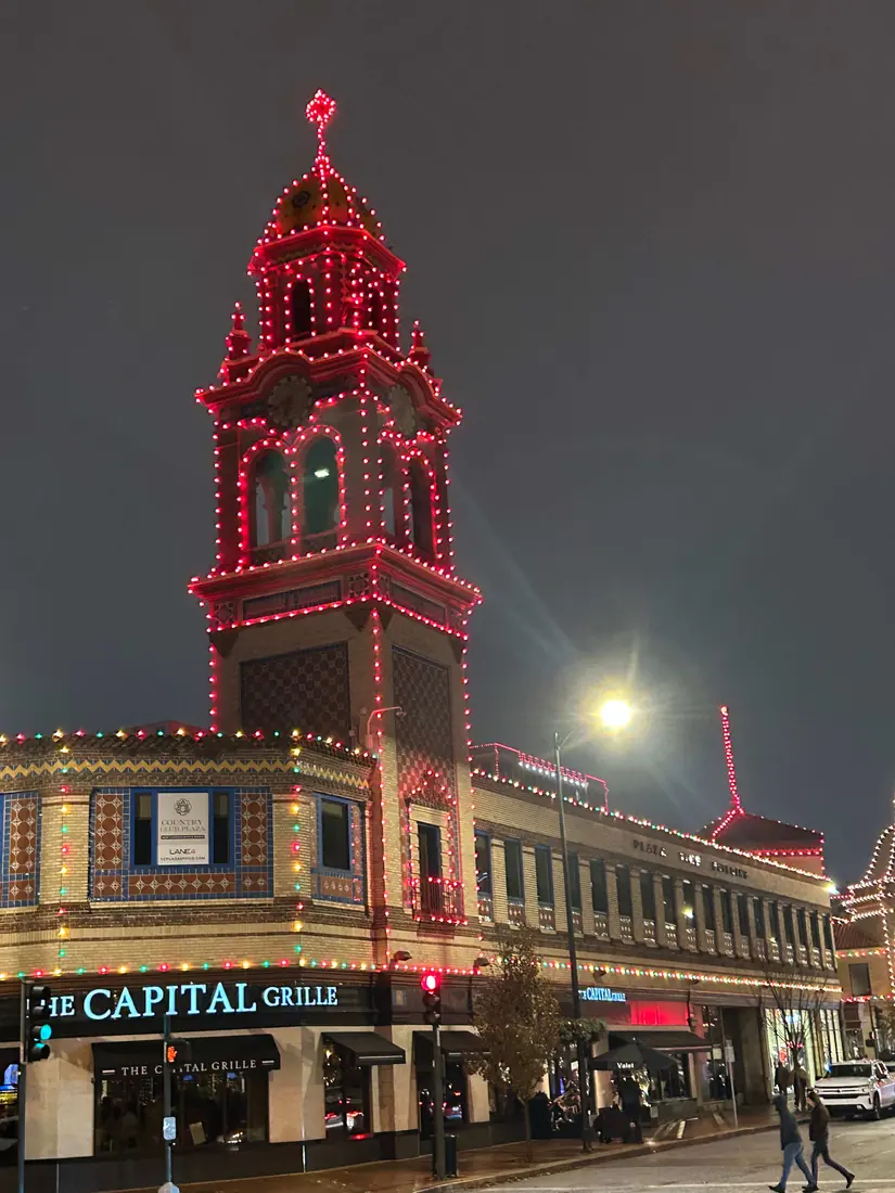 The Plaza's Giralda tower outlined in red and white holiday lights